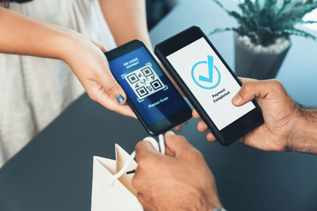 Person making a mobile payment by scanning a dynamic QR code on a smartphone, illustrating real-time digital transactions and secure payment processing with dynamic QR codes.